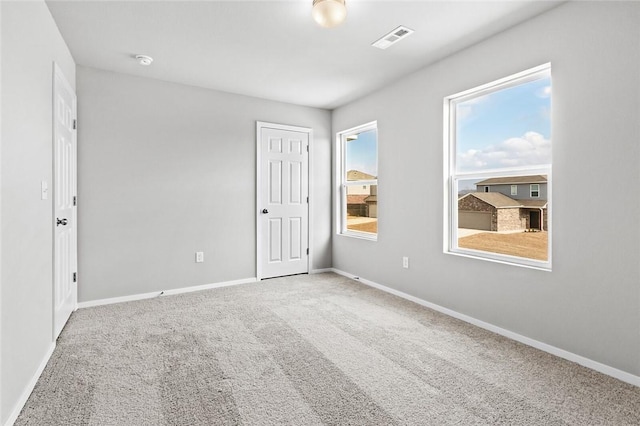 unfurnished bedroom with carpet flooring and baseboards
