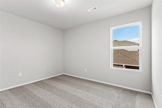empty room with baseboards and carpet flooring