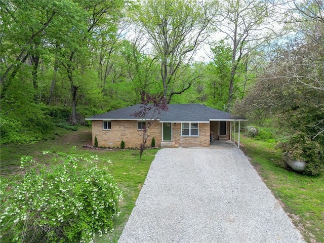 16106 Boundary Line Rd, Garfield, AR 72732 - single story home featuring gravel driveway, brick siding, a wooded view, a front yard, and roof with shingles