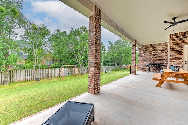 view of patio / terrace featuring a playground, ceiling fan, and grilling area