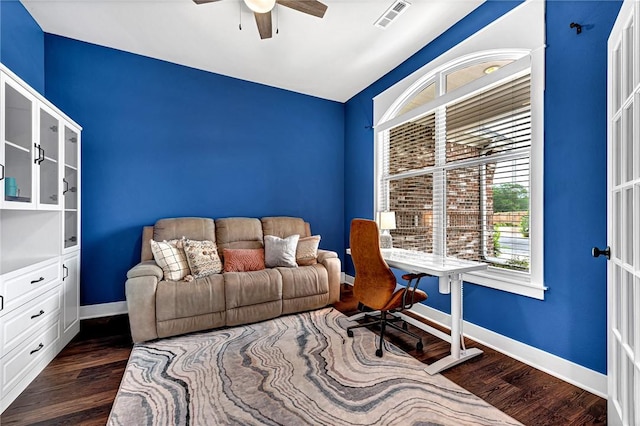 office area featuring ceiling fan, dark wood finished floors, and baseboards