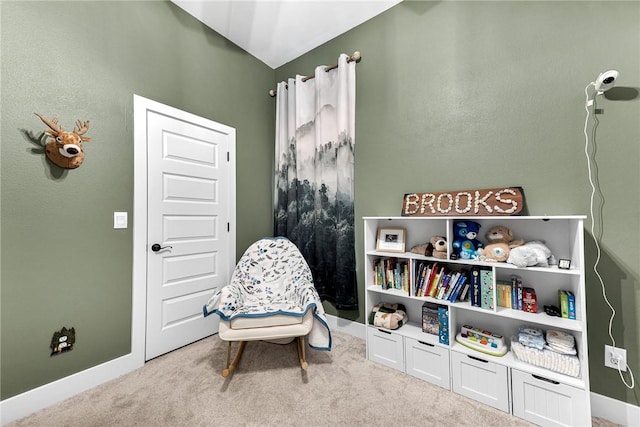 sitting room with carpet floors, baseboards, and lofted ceiling
