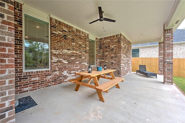 view of patio / terrace with fence and ceiling fan