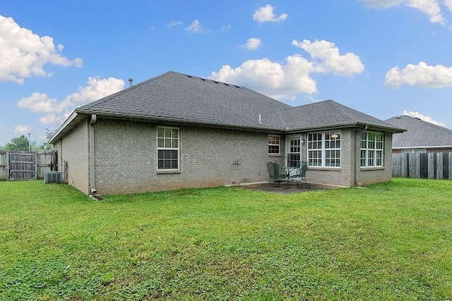 rear view of house featuring central AC unit, a patio area, roof with shingles, and brick siding