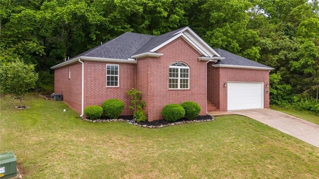 701 W Thornstone Ave, West Fork, AR 72774 - view of front of home featuring an attached garage, driveway, brick siding, a front lawn, and a shingled roof