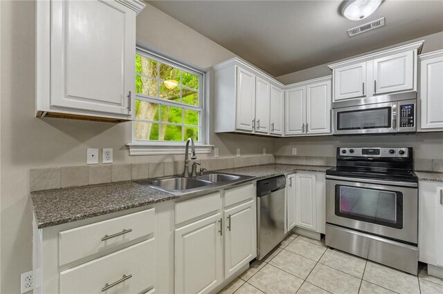 701 W Thornstone Ave, West Fork, AR 72774 - kitchen featuring stainless steel appliances, a sink, light tile patterned floors, and white cabinetry