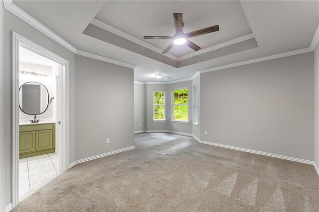 701 W Thornstone Ave, West Fork, AR 72774 - empty room featuring a raised ceiling, light colored carpet, a ceiling fan, ornamental molding, and baseboards