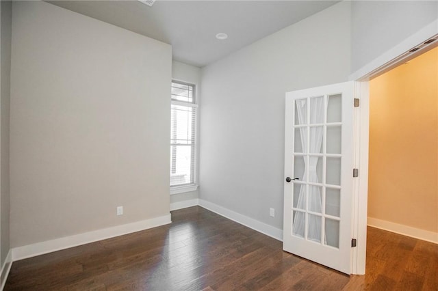 empty room with baseboards and wood finished floors