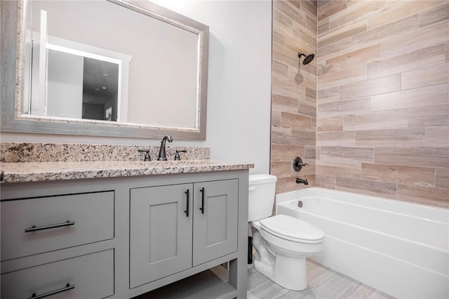 bathroom with toilet, vanity, and shower / bath combination