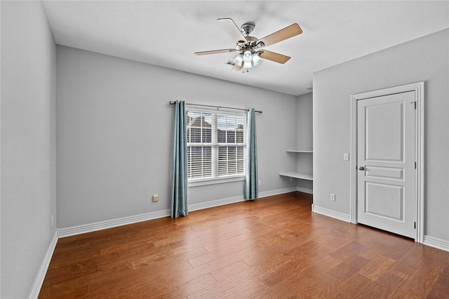3907 NE Cadbury Ave, Bentonville, AR 72712 - spare room featuring ceiling fan, wood finished floors, and baseboards