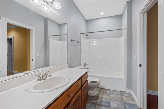 3907 NE Cadbury Ave, Bentonville, AR 72712 - bathroom featuring vanity, toilet, shower / tub combination, baseboards, and stone finish floors