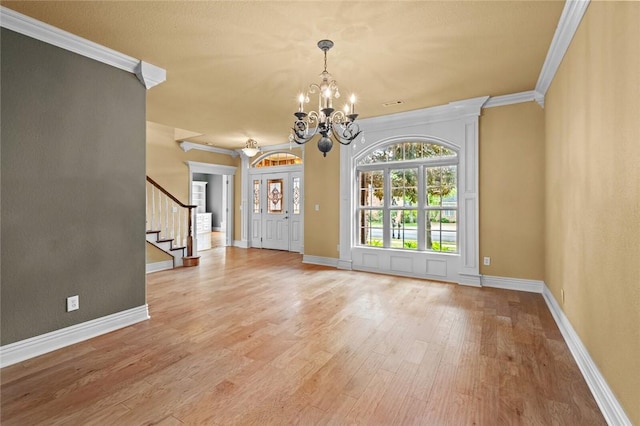 3907 NE Cadbury Ave, Bentonville, AR 72712 - entryway featuring ornamental molding, a chandelier, light wood-style floors, stairway, and baseboards