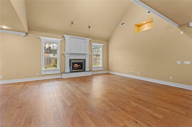 3907 NE Cadbury Ave, Bentonville, AR 72712 - unfurnished living room featuring light wood-style flooring, high vaulted ceiling, baseboards, and a fireplace