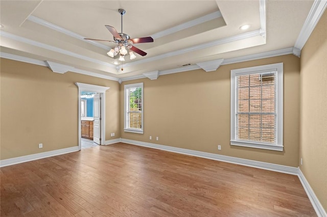 3907 NE Cadbury Ave, Bentonville, AR 72712 - empty room featuring crown molding, a tray ceiling, a ceiling fan, light wood-style floors, and baseboards