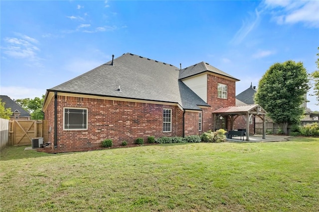 3907 NE Cadbury Ave, Bentonville, AR 72712 - back of house featuring a gazebo, central air condition unit, brick siding, and a shingled roof