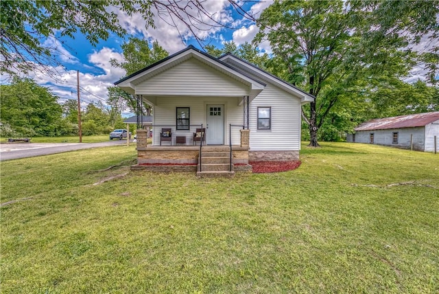 view of front of house with a porch and a front lawn