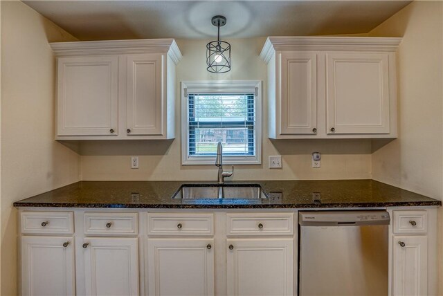 kitchen featuring stainless steel dishwasher, a sink, and white cabinets