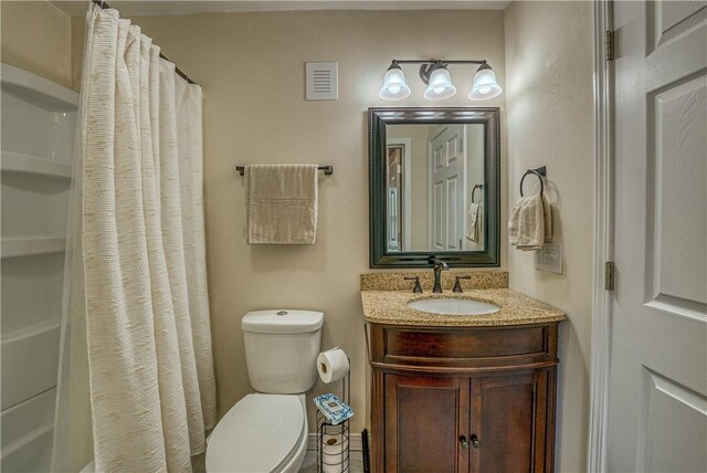 bathroom with toilet and vanity
