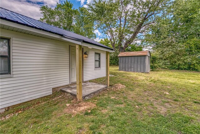 entrance to property with a yard and metal roof