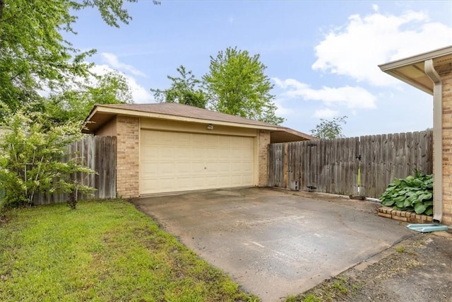 garage featuring concrete driveway