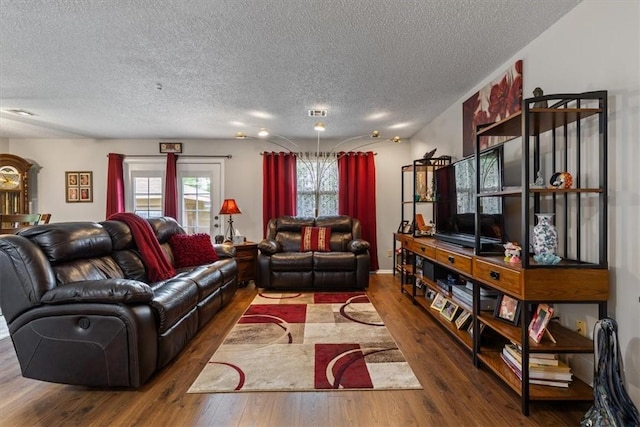 living area featuring a textured ceiling and wood-type flooring
