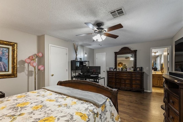 bedroom with dark wood-style floors, a textured ceiling, a ceiling fan, connected bathroom, and baseboards