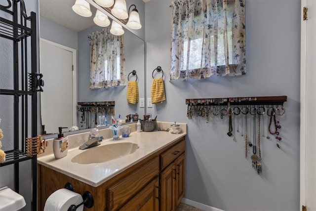 bathroom with vanity and a chandelier