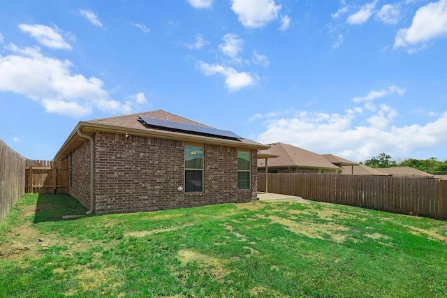 6005 Sherman St, Bentonville, AR 72713 - back of house featuring brick siding, solar panels, and a patio area