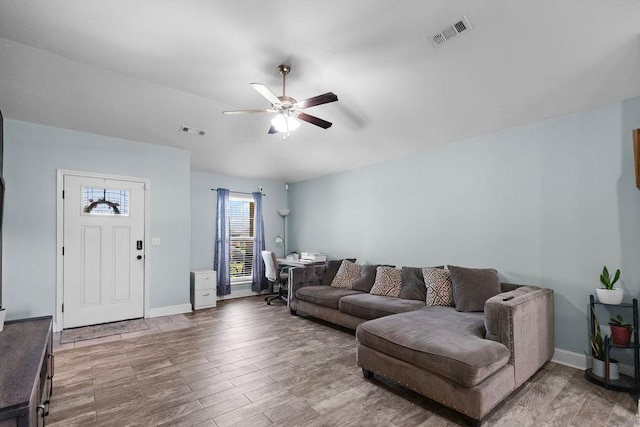 6005 Sherman St, Bentonville, AR 72713 - living area featuring ceiling fan, wood finished floors, baseboards, and vaulted ceiling
