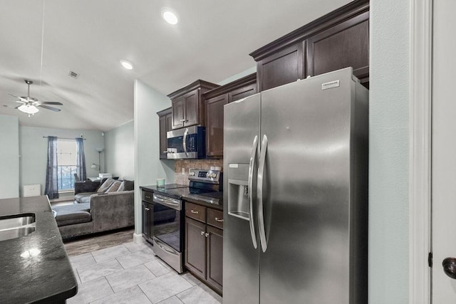 6005 Sherman St, Bentonville, AR 72713 - kitchen with appliances with stainless steel finishes, open floor plan, dark brown cabinetry, ceiling fan, and tasteful backsplash