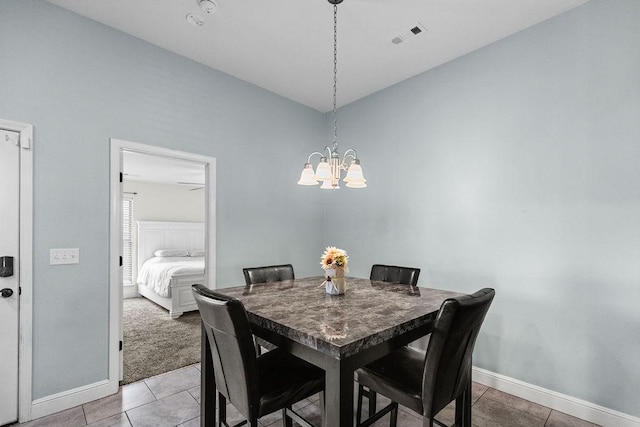 6005 Sherman St, Bentonville, AR 72713 - dining area featuring baseboards, a chandelier, and light tile patterned flooring