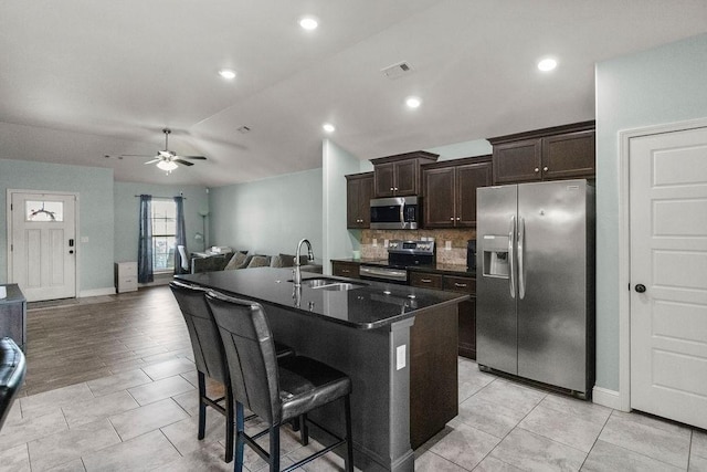 6005 Sherman St, Bentonville, AR 72713 - kitchen with stainless steel appliances, a sink, ceiling fan, a kitchen breakfast bar, and open floor plan