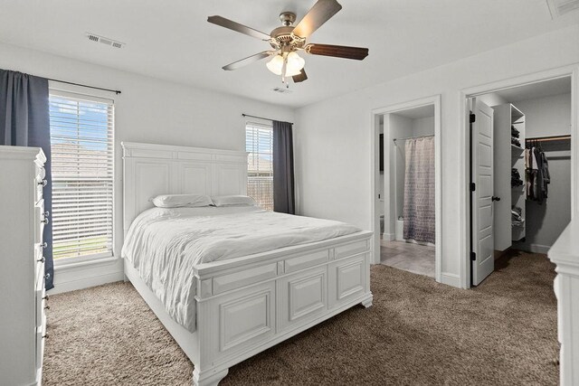 6005 Sherman St, Bentonville, AR 72713 - bedroom with carpet flooring, baseboards, ensuite bathroom, a spacious closet, and a ceiling fan