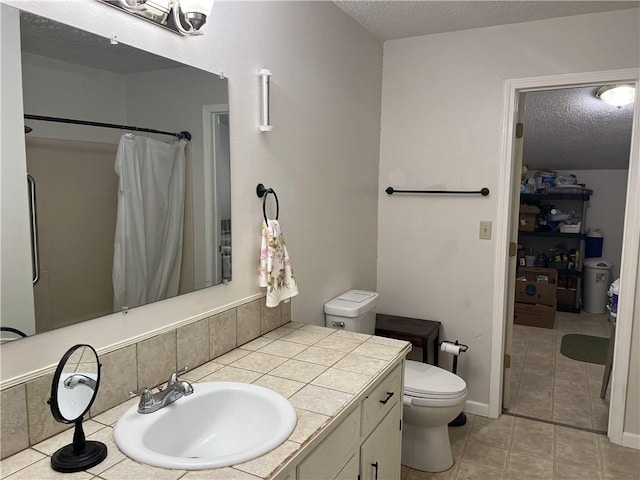 bathroom with a textured ceiling, toilet, tile patterned flooring, vanity, and a shower with shower curtain