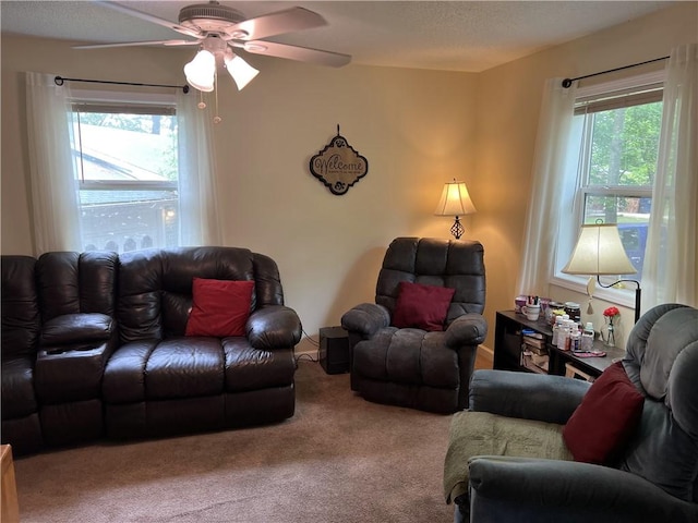 living area with carpet flooring and ceiling fan