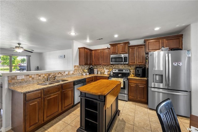 4208 SW Fieldstone Blvd, Bentonville, AR 72712 - kitchen with appliances with stainless steel finishes, a sink, a peninsula, decorative backsplash, and recessed lighting