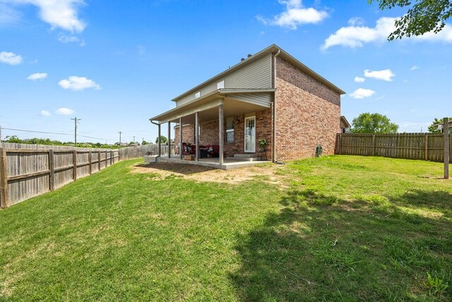 4208 SW Fieldstone Blvd, Bentonville, AR 72712 - rear view of house featuring brick siding and a patio area