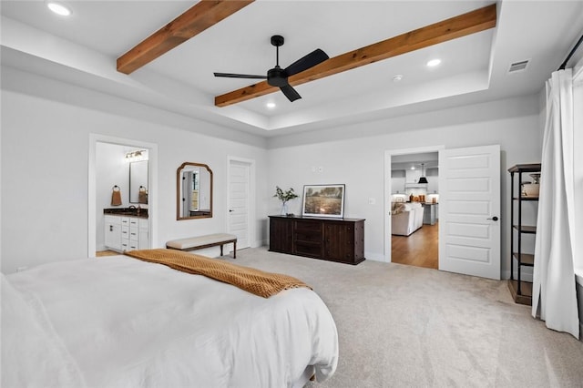 bedroom with beam ceiling, light colored carpet, recessed lighting, ensuite bathroom, and a ceiling fan