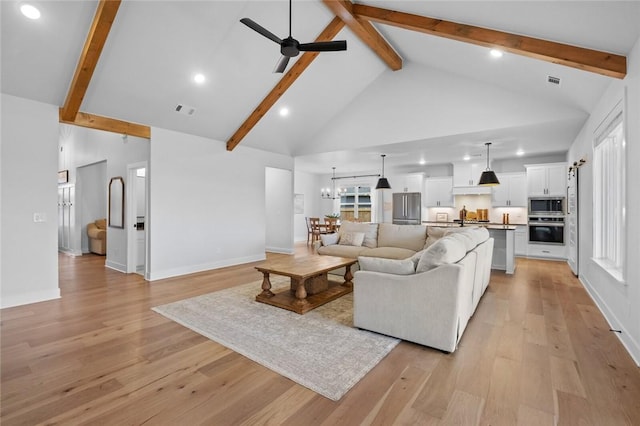 living area with ceiling fan, beamed ceiling, high vaulted ceiling, light wood-type flooring, and recessed lighting