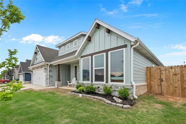 back of property featuring stone siding, board and batten siding, a garage, and concrete driveway
