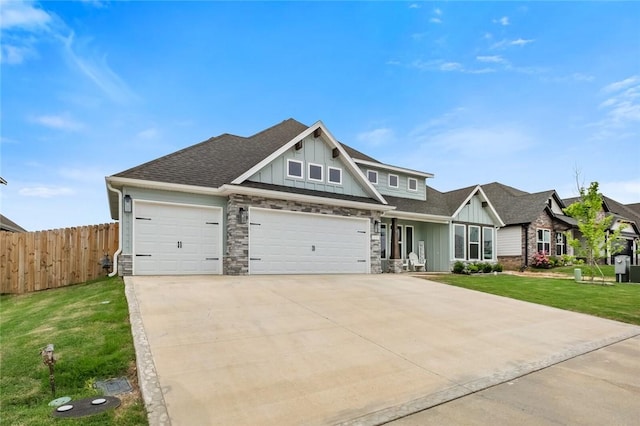 craftsman-style house featuring board and batten siding, a garage, driveway, and a shingled roof