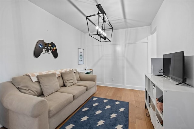 living room with a chandelier and light wood-style floors