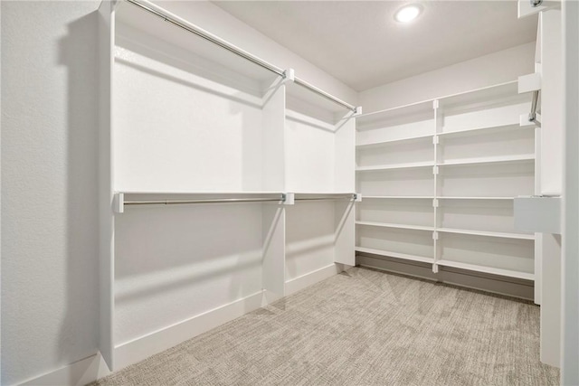 walk in closet with carpet