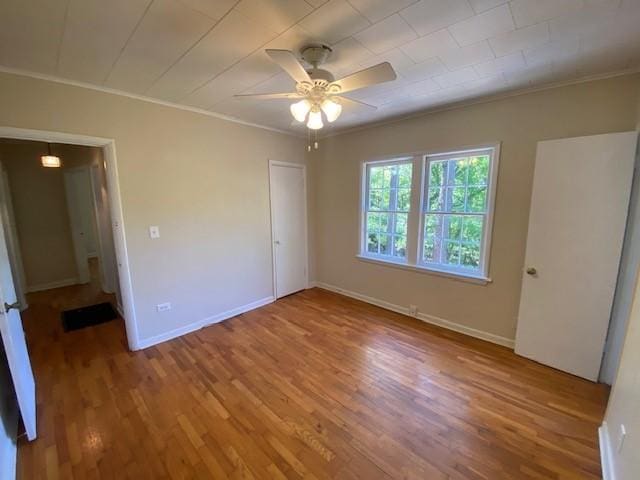 449 N Assembly Dr, Fayetteville, AR 72701 - unfurnished bedroom featuring ornamental molding, wood finished floors, baseboards, and ceiling fan