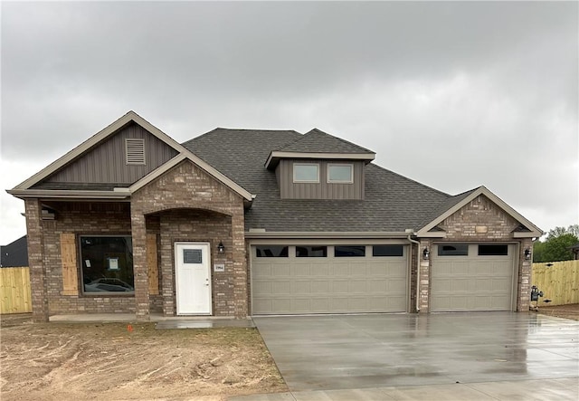 craftsman-style house with brick siding, driveway, a garage, and board and batten siding