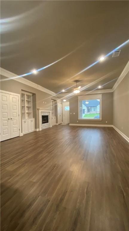 1908 Hale Ln, Pea Ridge, AR 72751 - unfurnished living room featuring dark wood-style floors, a ceiling fan, a fireplace, baseboards, and built in shelves