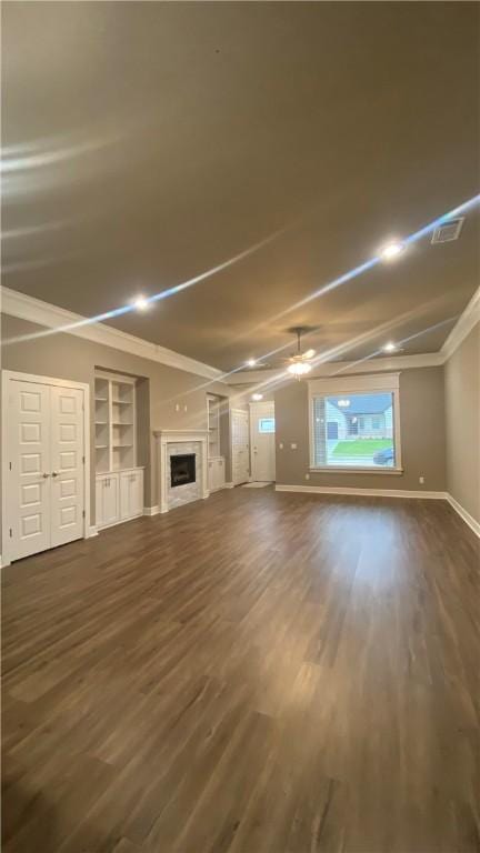 1908 Hale Ln, Pea Ridge, AR 72751 - unfurnished living room featuring dark wood finished floors, a ceiling fan, a fireplace, baseboards, and ornamental molding