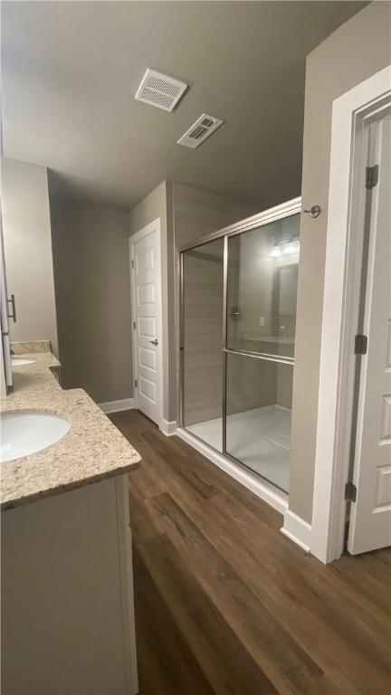 1908 Hale Ln, Pea Ridge, AR 72751 - full bathroom with vanity, wood finished floors, baseboards, and a stall shower