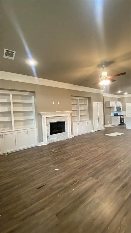 1912 Hale Ln, Pea Ridge, AR 72751 - unfurnished living room featuring crown molding, ceiling fan, dark wood finished floors, built in features, and baseboards