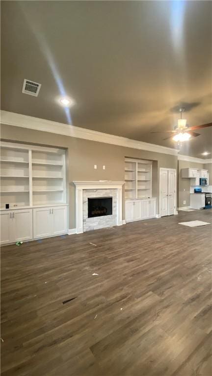 1912 Hale Ln, Pea Ridge, AR 72751 - unfurnished living room with crown molding, built in shelves, a ceiling fan, dark wood-style floors, and a fireplace